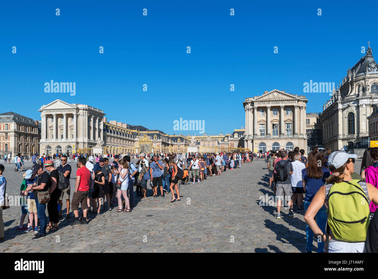 Long lines of people waiting to get through security checks at the Chateau de Versailles (Palace of Versailles), near Paris, France Stock Photo
