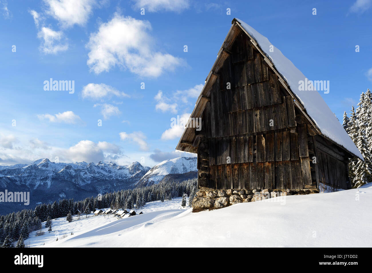 Mountain hut on the snowy meadow, Zajmniki, Pokljuka, Slovenia Stock Photo