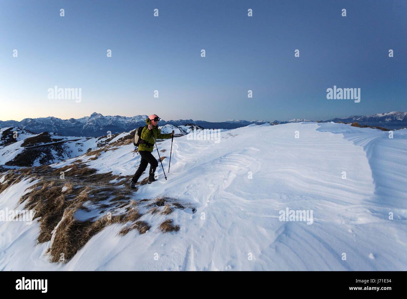 Woman hiking in the snowy mountains, Slatnik, Slovenia Stock Photo - Alamy