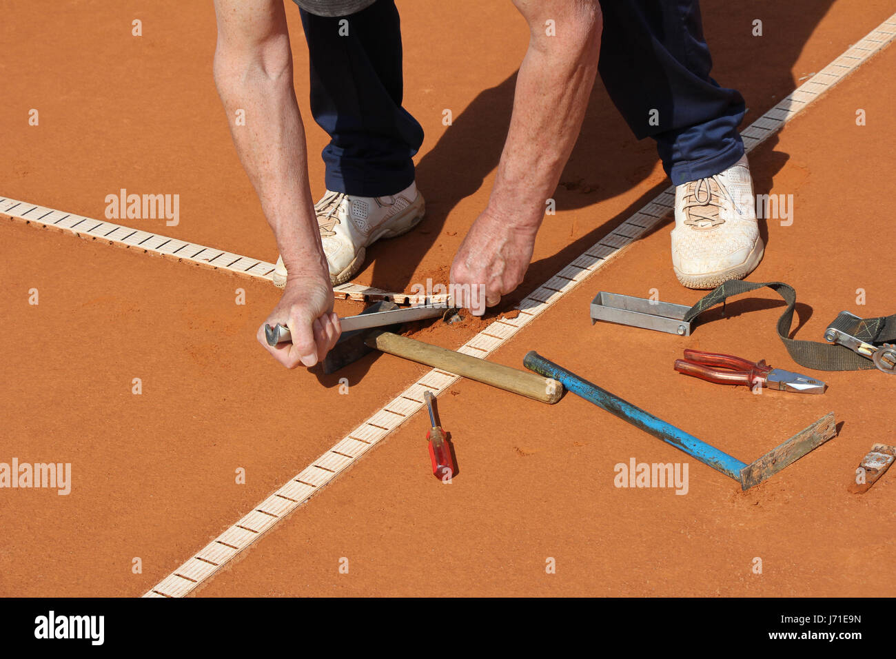 Worker Repairing lines on a tennis court Stock Photo Alamy