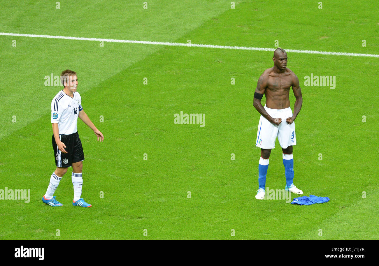 FILE - A file picture dated 28 June 2012 shows Germany's Philipp Lahm (L) and Italy's Mario Balotelli reacting during the UEFA EURO 2012 semi-final between Germany and Italy in Warsaw, Poland. (Please refer to chapters 7 and 8 of http://dpaq.de/Ziovh for UEFA Euro 2012 Terms & Conditions) Photo: Marcus Brandt/dpa Stock Photo