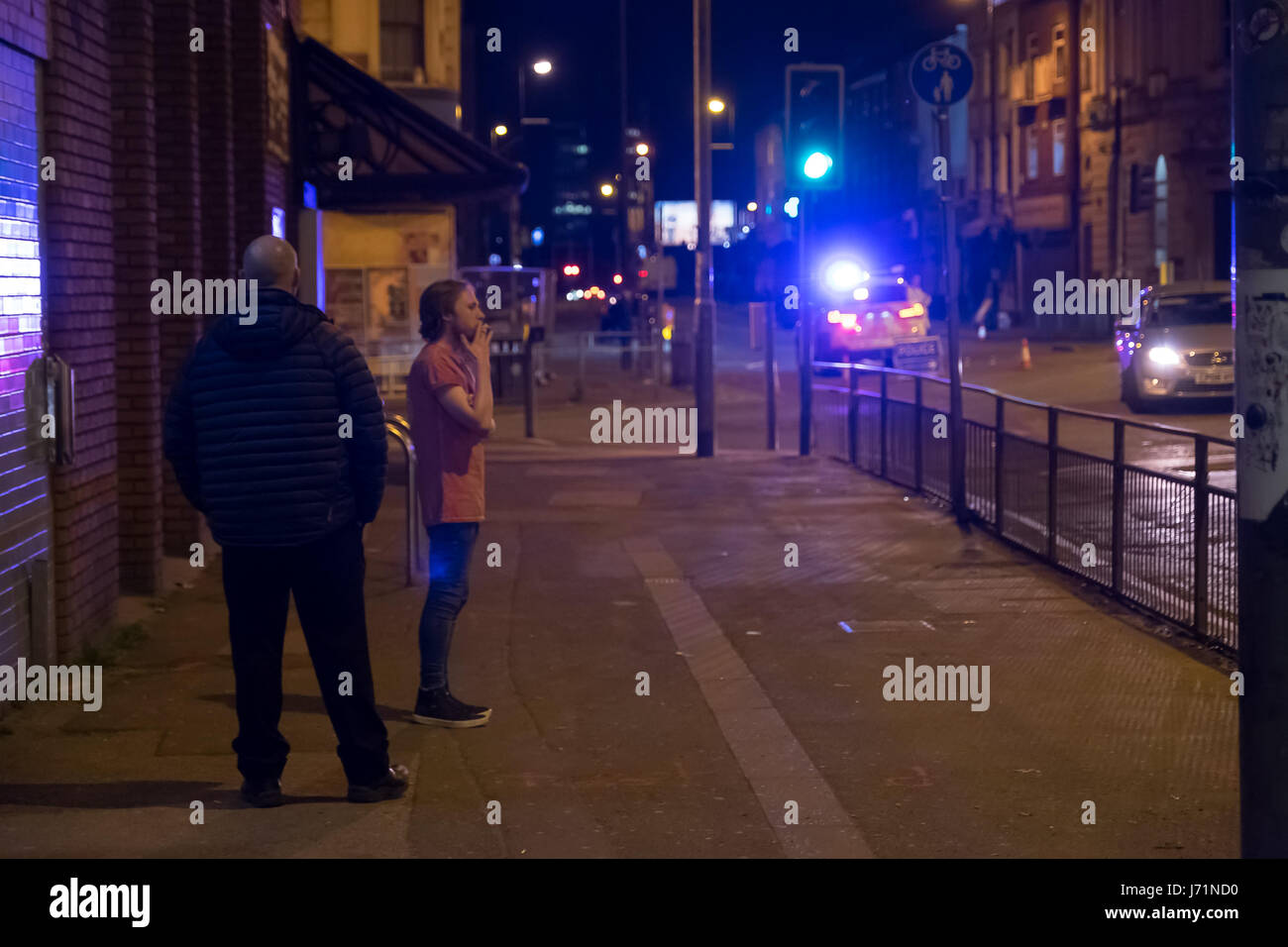 Manchester UK. Tuesday 23rd May 2017. Bystanders look on at police cordon on Ring Road junction Oldham Street. 22 people confirmed dead after explosion at an Ariana Grande concert at Manchester Arena. Copyright Credit: Ian Wray/Alamy Live News Stock Photo