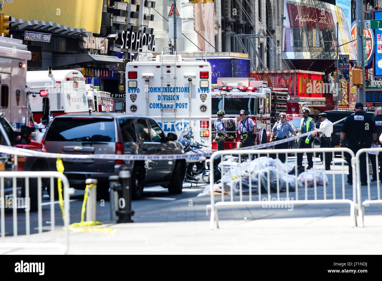 Police officers secure the area near a car after it plunged into pedestrians in Times Square in New York on May 18, 2017. The man who drove a car into a crowd in Times Square on Thursday, killing one person and injuring 22 others, served in the US Navy and has a criminal record, New York's mayor said, adding authorities did not believe it was a terror attack. (PHOTO: WILLIAM VOLCOV/BRAZIL PHOTO PRESS) Stock Photo