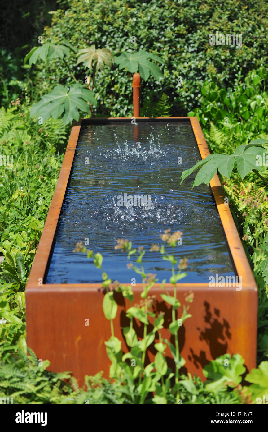 London, UK. 22nd May, 2017. Water in a trough rippling as underwater speakers play music in the Zoe Ball Listening Garden (designed by James Alexander-Sinclair), one of the beautiful and elegant show gardens on display at the 2017 RHS Chelsea Flower Show which opened today in the 11-acre grounds of the Royal Hospital Chelsea, London, United Kingdom.  Held since 1913, the five day event is the most prestigious flower and garden show in the United Kingdom, and perhaps in the world, and attracts around 165,000 visitors each year. Credit: Michael Preston/Alamy Live News Stock Photo
