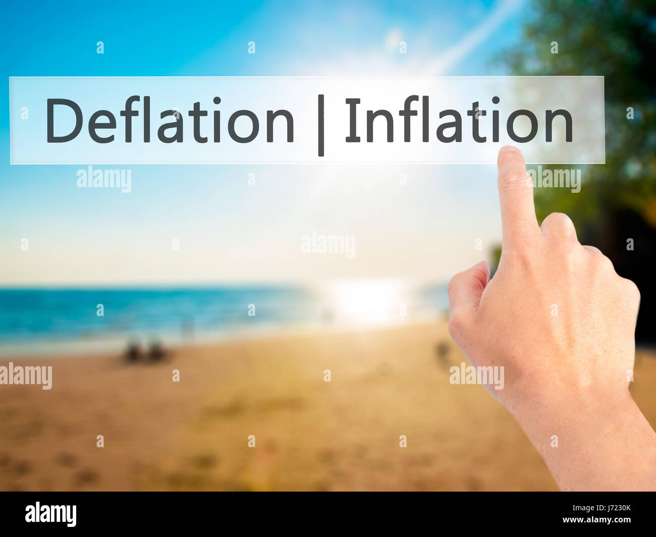 Deflation Inflation - Hand pressing a button on blurred background ...