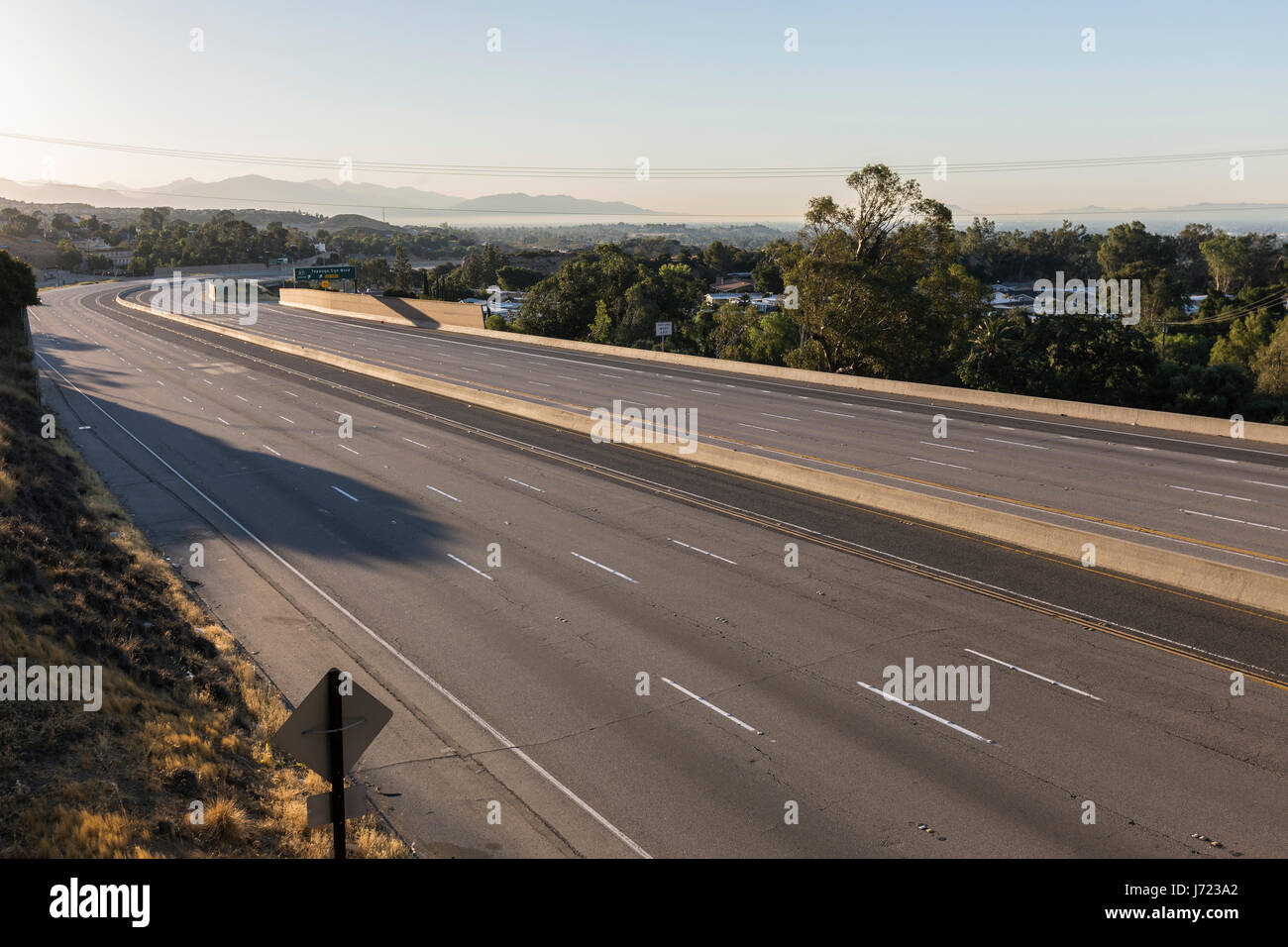 Empty ten lane freeway at sunrise in the San Fernando Valley area of Los Angeles, California. Stock Photo