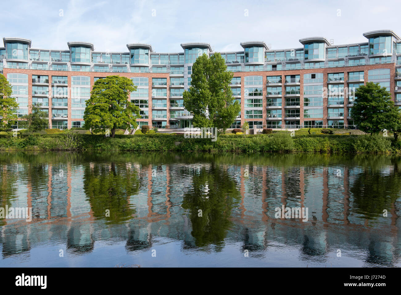 Riverside Crescent Luxury Apartments reflected in the River Trent in Nottingham, England UK