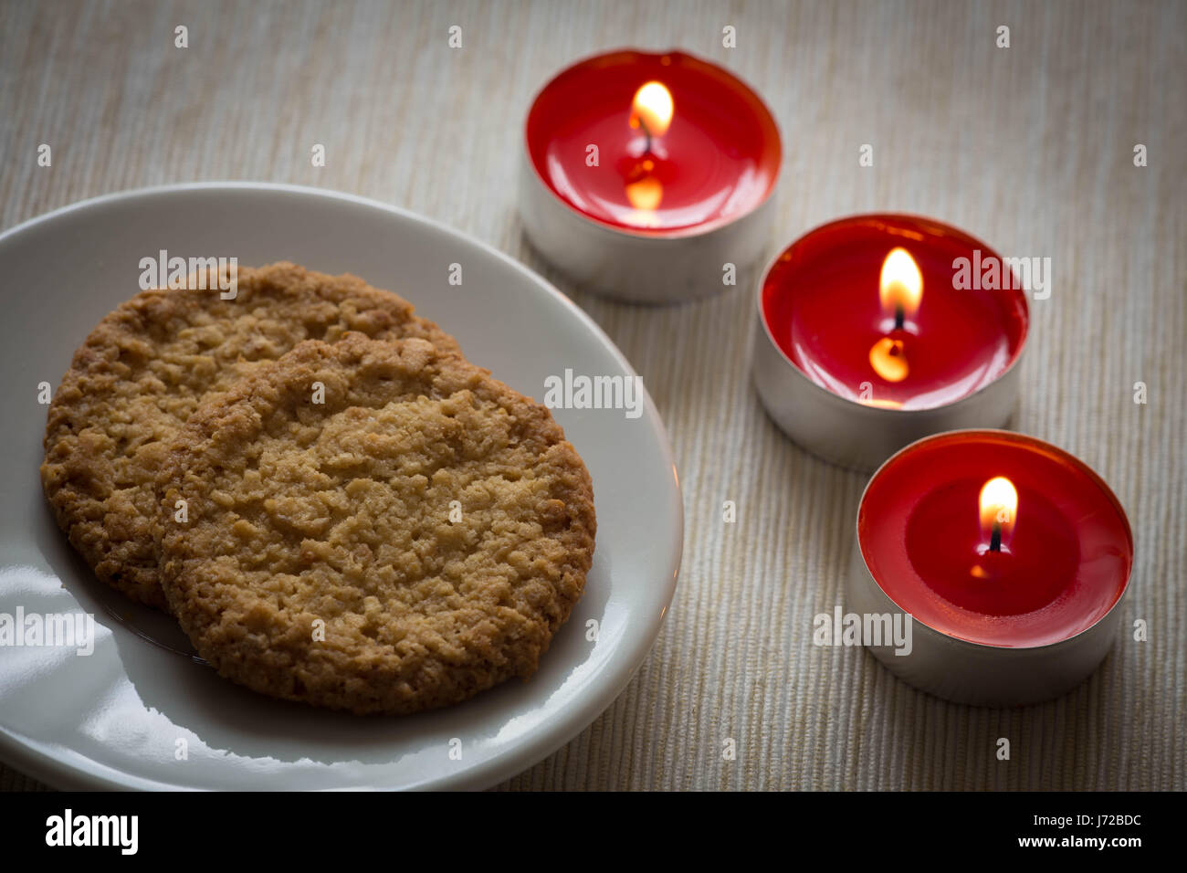 View of the Homemade cookies surrounded by candles, hygge time Stock Photo