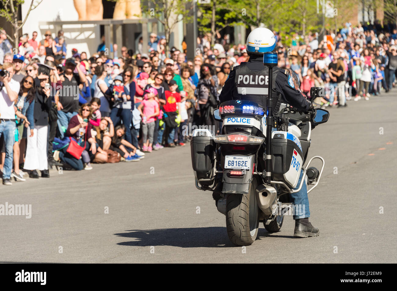 Montreal, CA - 20 May 2017: Police Officer on motorbike during Royal de Luxe Show Stock Photo