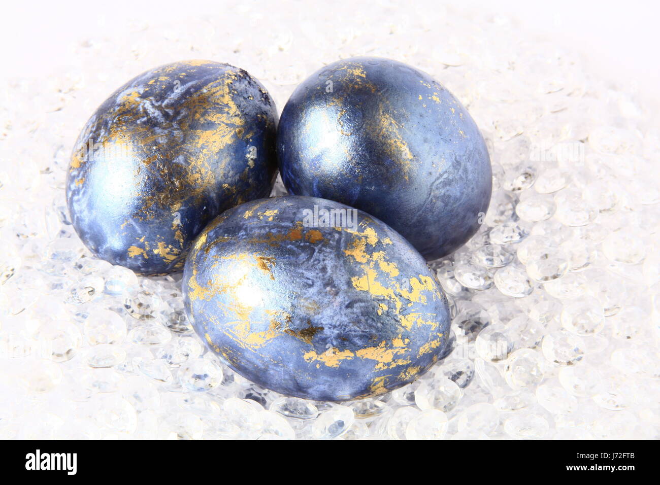 three easter eggs in blue and gold Stock Photo
