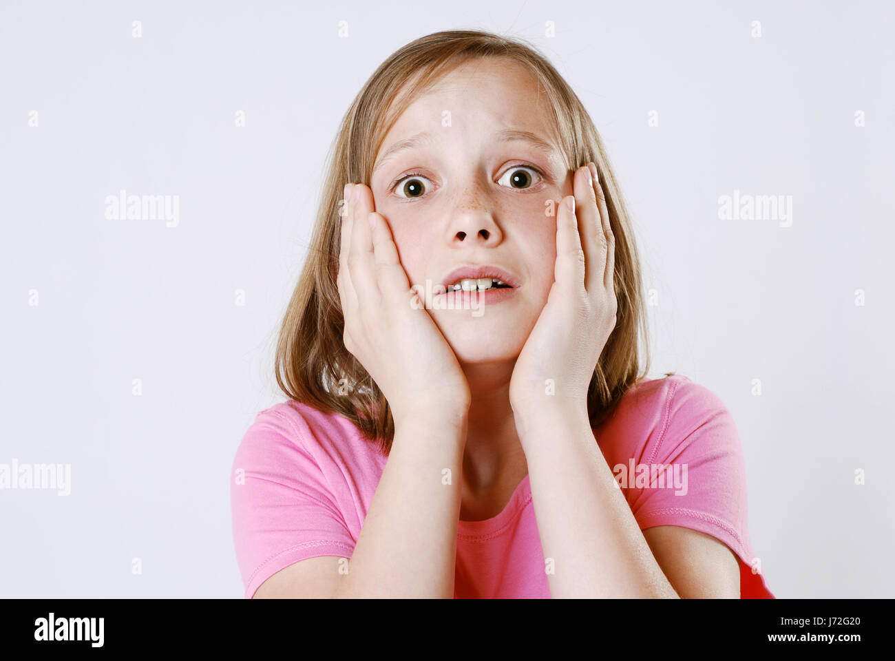 hand hands fear frightened cheek shocked frighten scare child girl