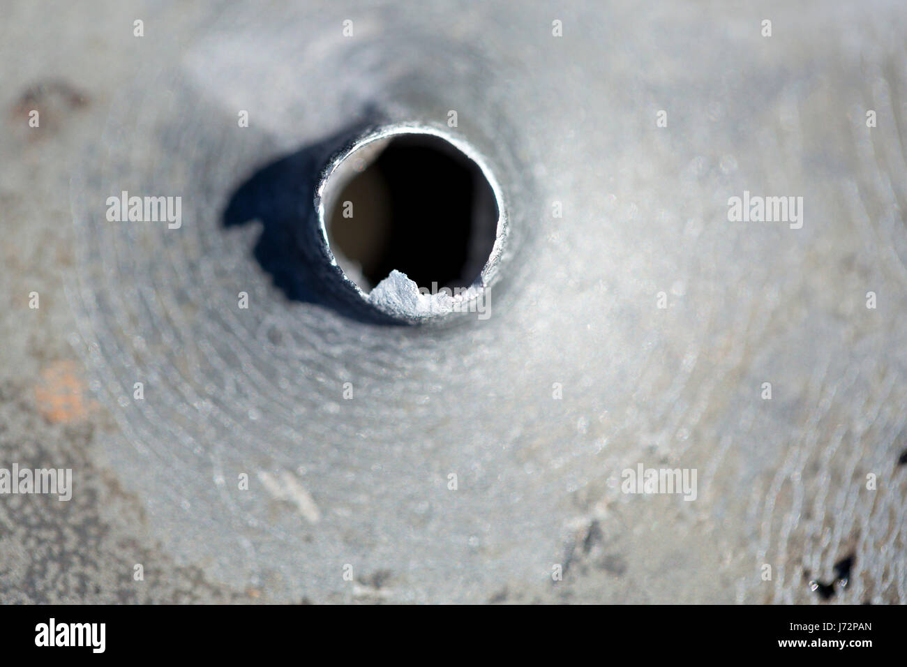 Macro shot of bullet holes after a target shooting in a aluminum pan. Stock Photo