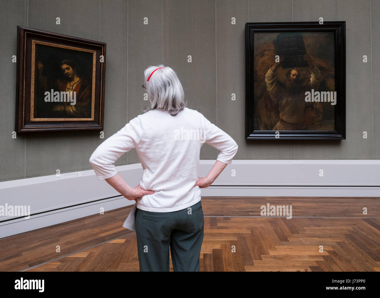 Woman looking at paintings inside Gemaldegalerie museum, at Kulturforum in Berlin, Germany Stock Photo