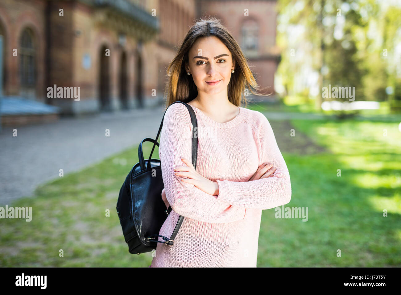 young female student with backpack walking in the park Stock Photo - Alamy