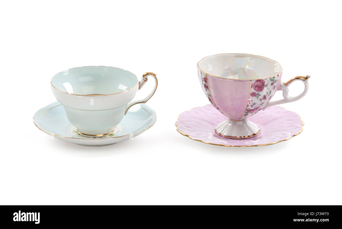High resolution close-up of four beautiful antique tea cups with saucers isolated on a white background. Stock Photo