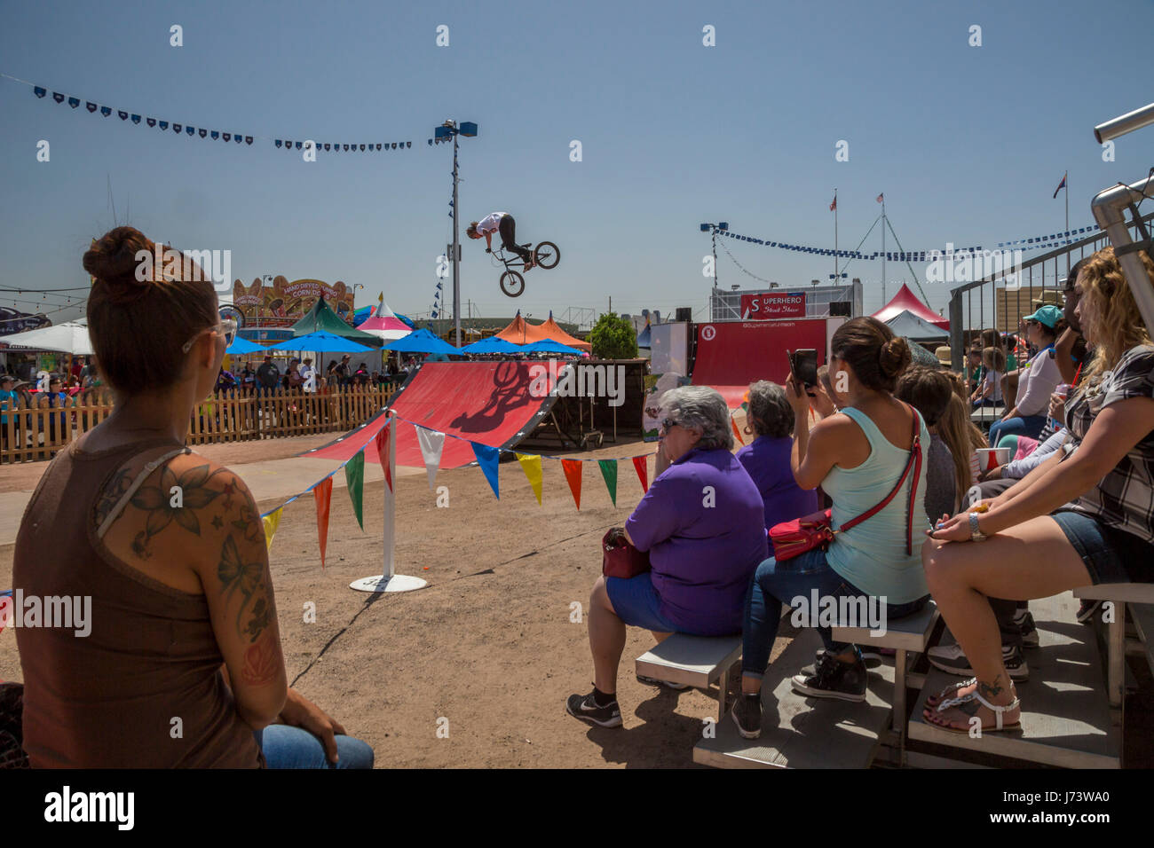 Phoenix, Arizona - Visitors to the Maricopa County Fair watch the Superhero Bicycle Stunt Show. Stock Photo