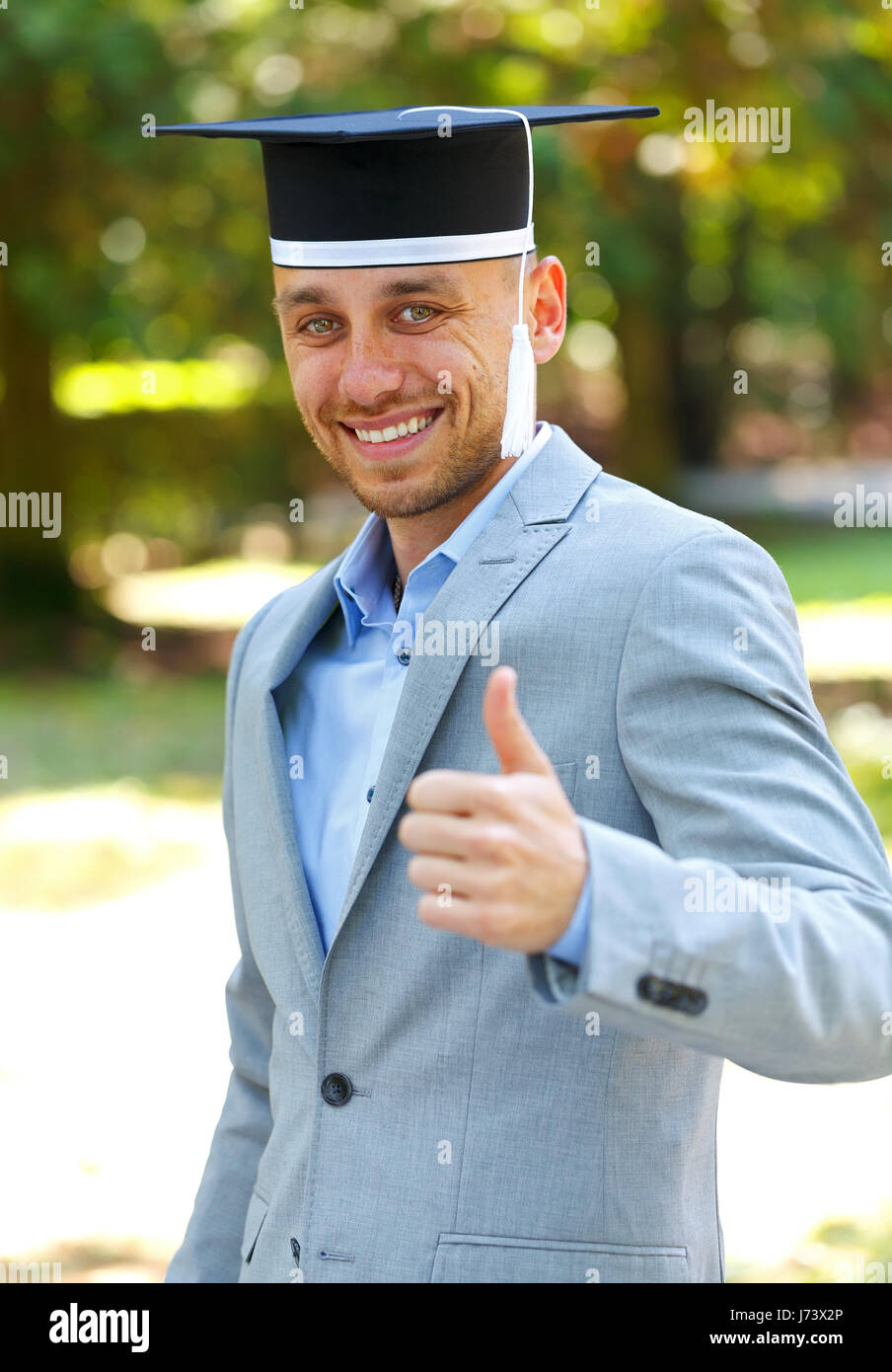 Happy graduateing student wearing graduation  hat Stock Photo