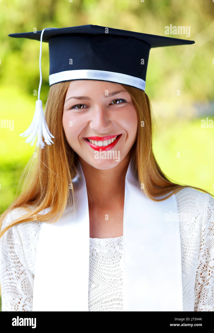 happy young woman wearing graduation hat Stock Photo Alamy