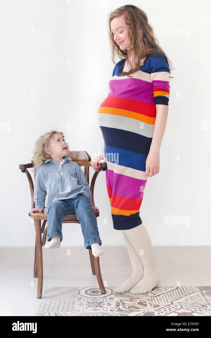 Full body portrait of Pregnant woman with child Stock Photo - Alamy