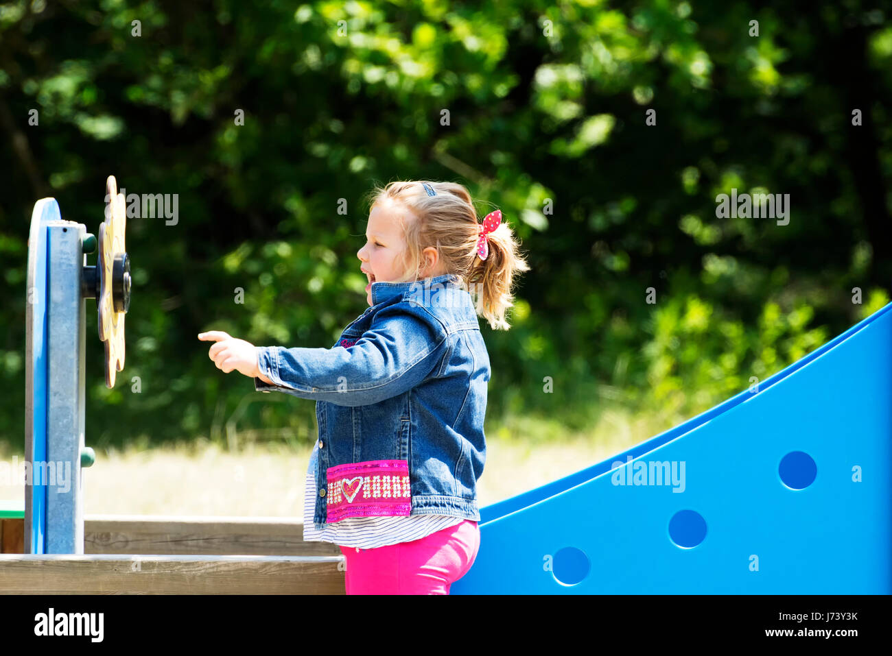 Happy little girl at playground Stock Photo - Alamy
