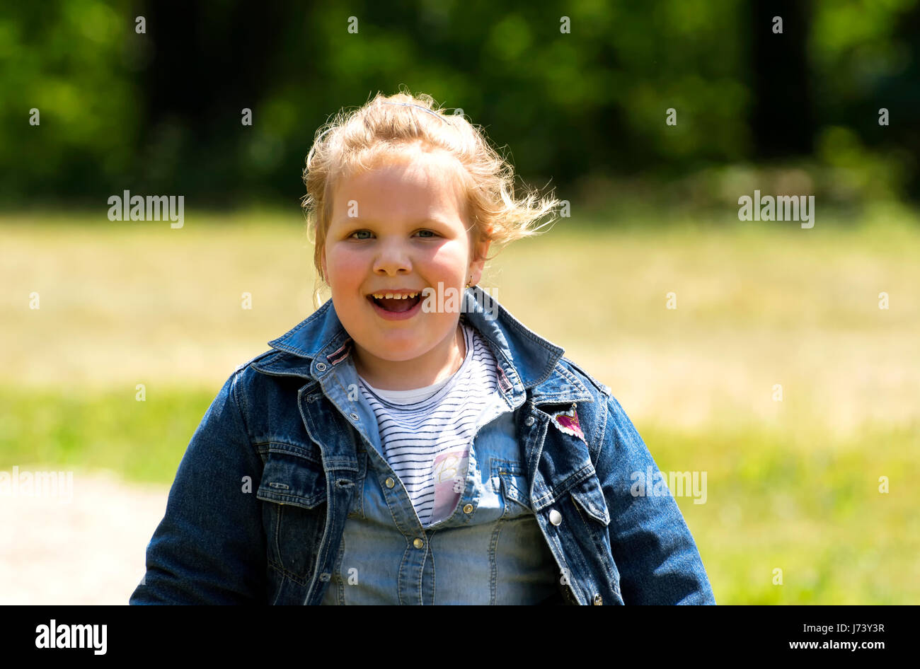 Happy little girl at playground Stock Photo - Alamy
