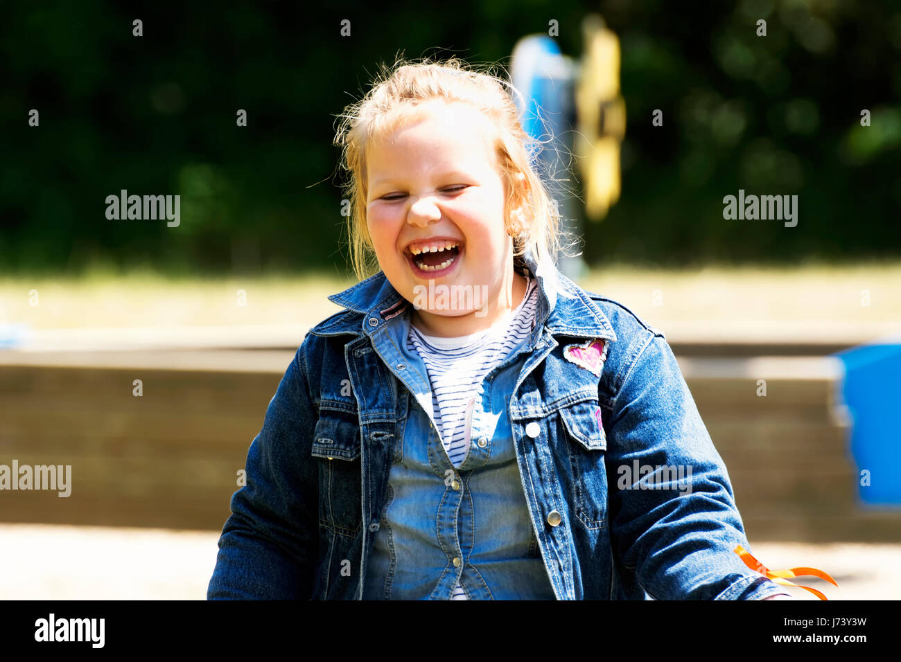 Happy little girl at playground Stock Photo