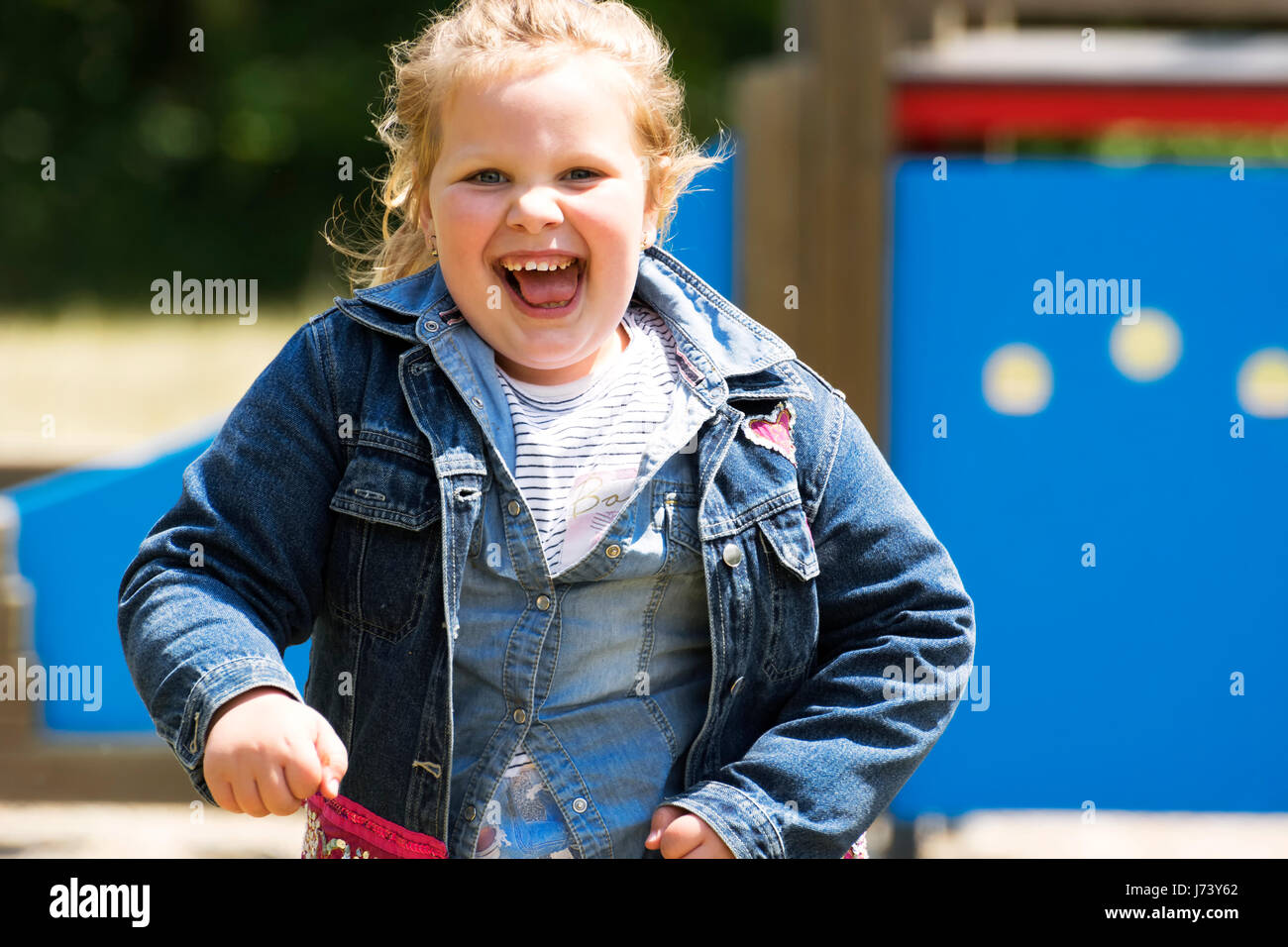 Happy little girl at playground Stock Photo - Alamy