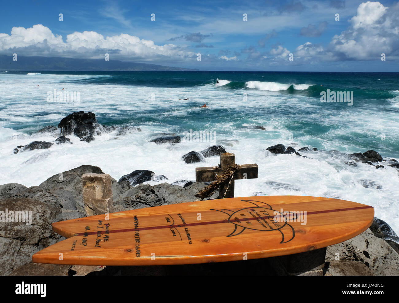 Wooden surf board and stone cross, a memorial to surfer Tristan Brennan