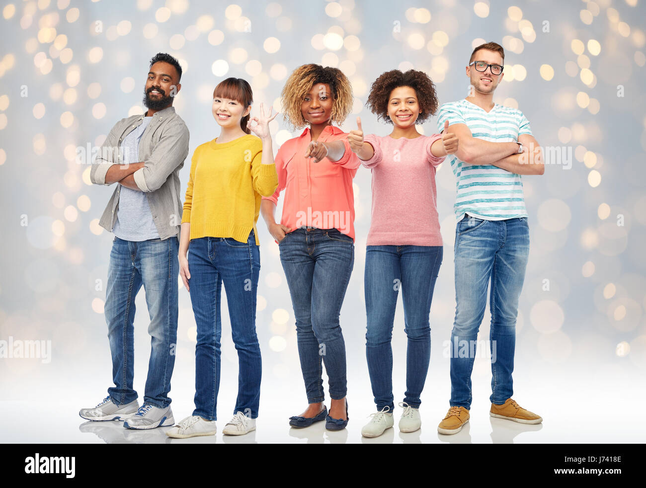 international group of happy people over lights Stock Photo