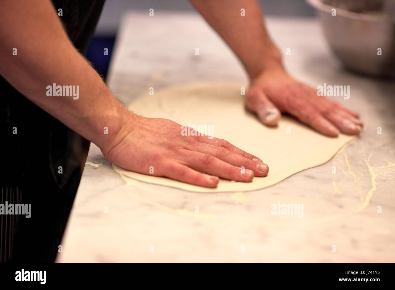 chef hands preparing dough on table at kitchen Stock Photo