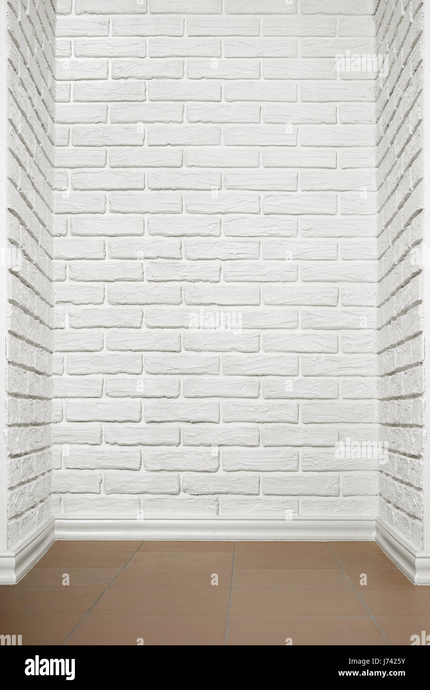 white brick wall with tiled floor, abstract background photo Stock