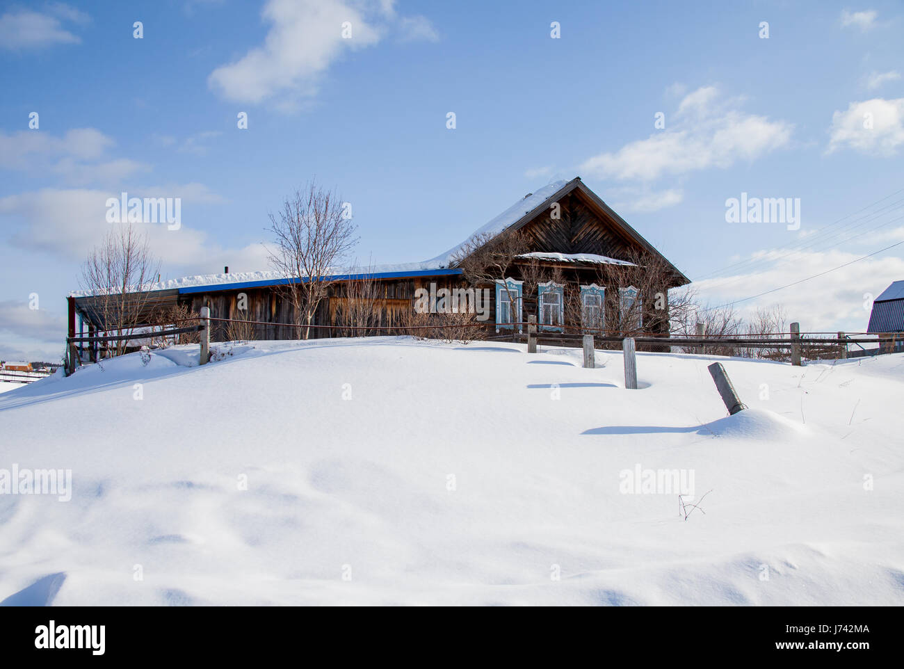 Wooden house in the village of Sloboda winter, Sverdlovsk region, Russia Stock Photo