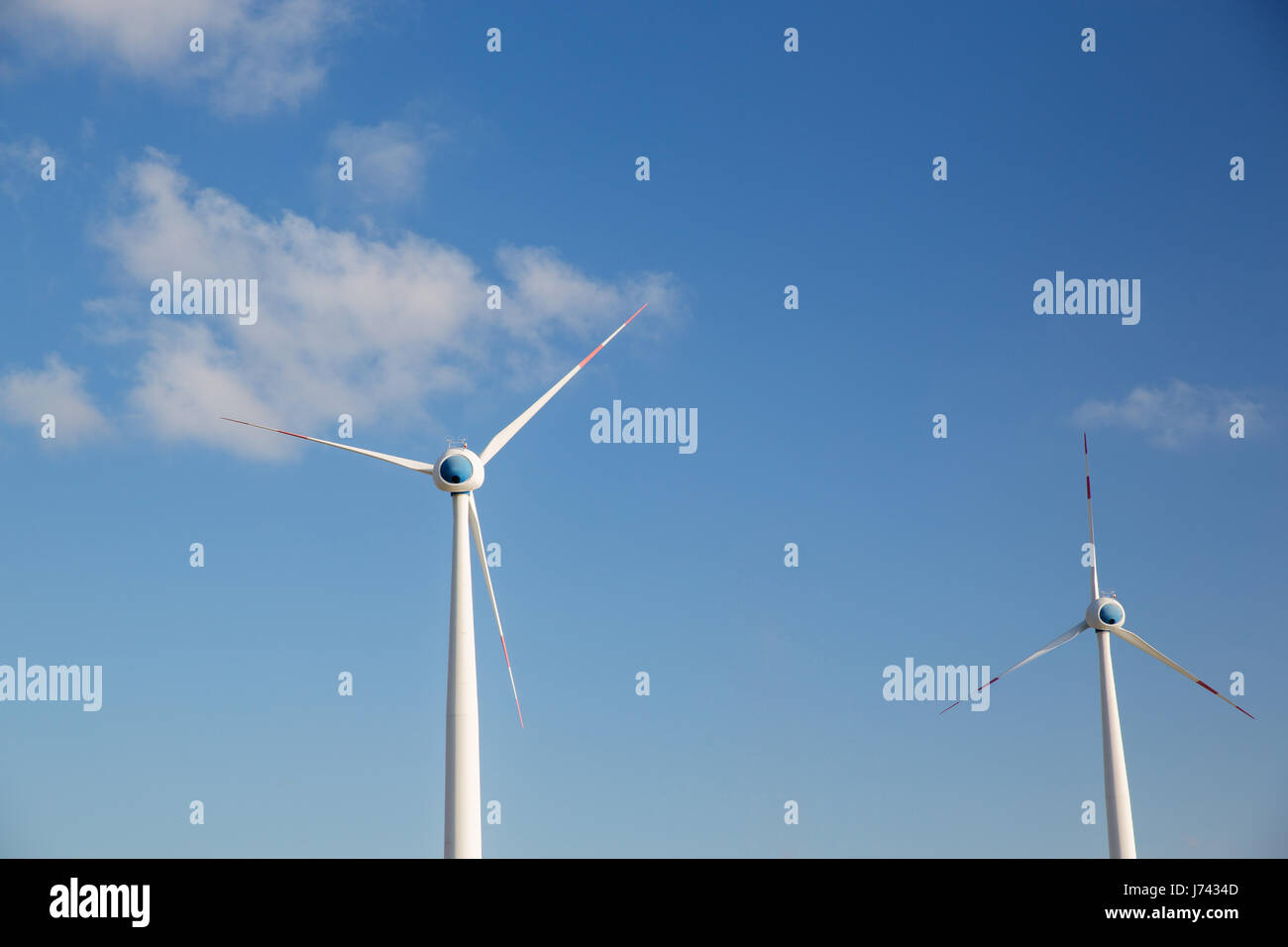 wind turbines over blue sky Stock Photo - Alamy