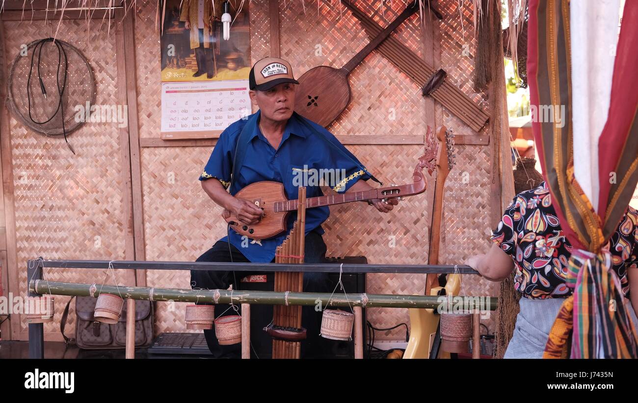 Man playing Traditional Thai Musical  instrument Thai Culture Festival Fair on Beach Road Pattaya Thailand Stock Photo