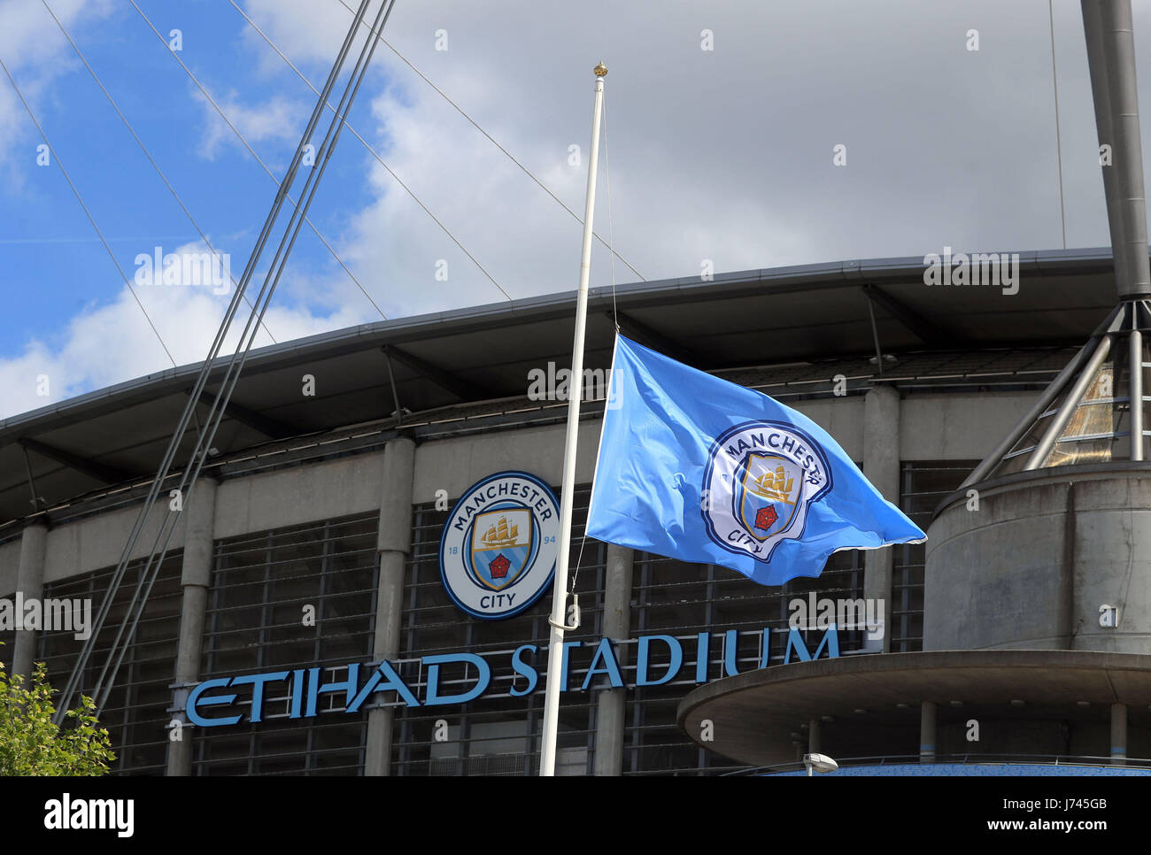 A Manchester City Flag Flies At Half Mast At The Eithad Stadium In Stock Photo Alamy
