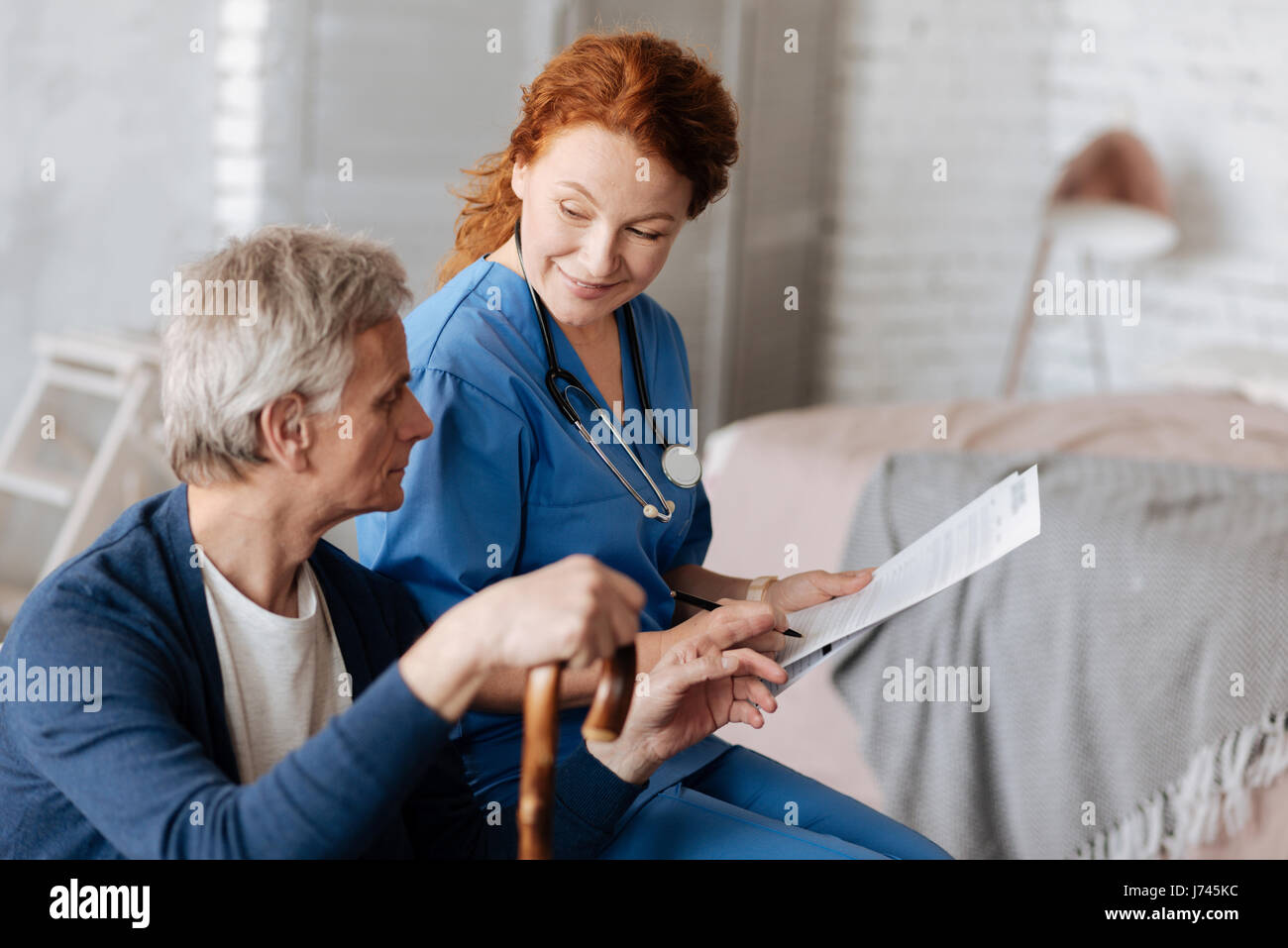 Energetic king doctor explaining her patient the process of treatment ...