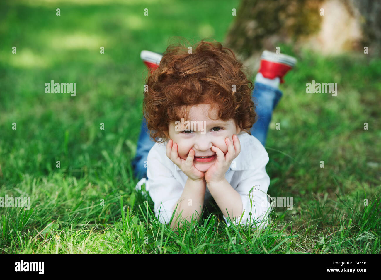 little modern boy on the grass Stock Photo Alamy