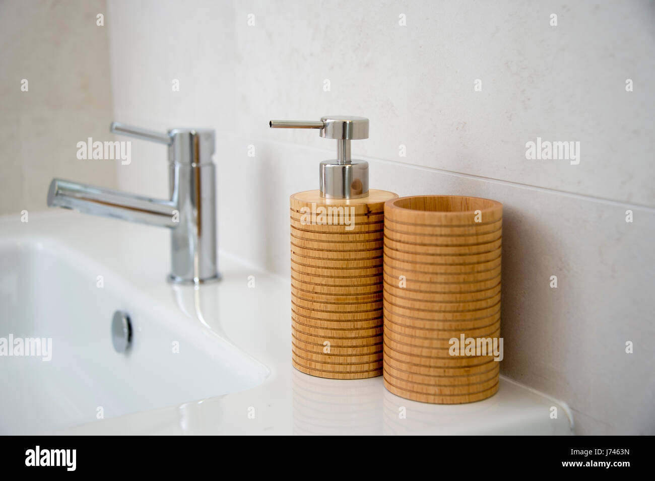 soap dispenser and toothbrush holder on a bathroom sink Stock Photo - Alamy
