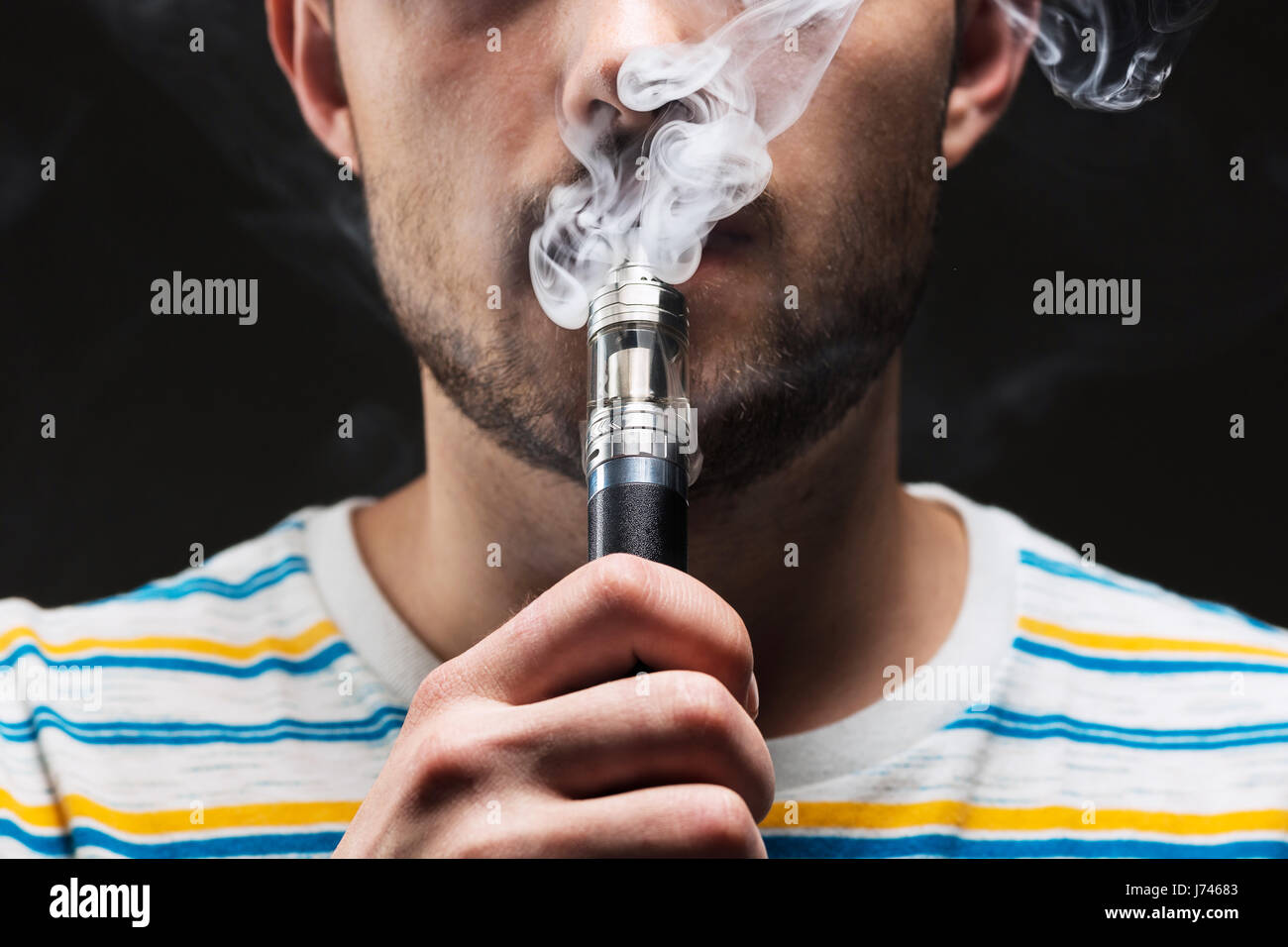 The face of vaping young man Stock Photo