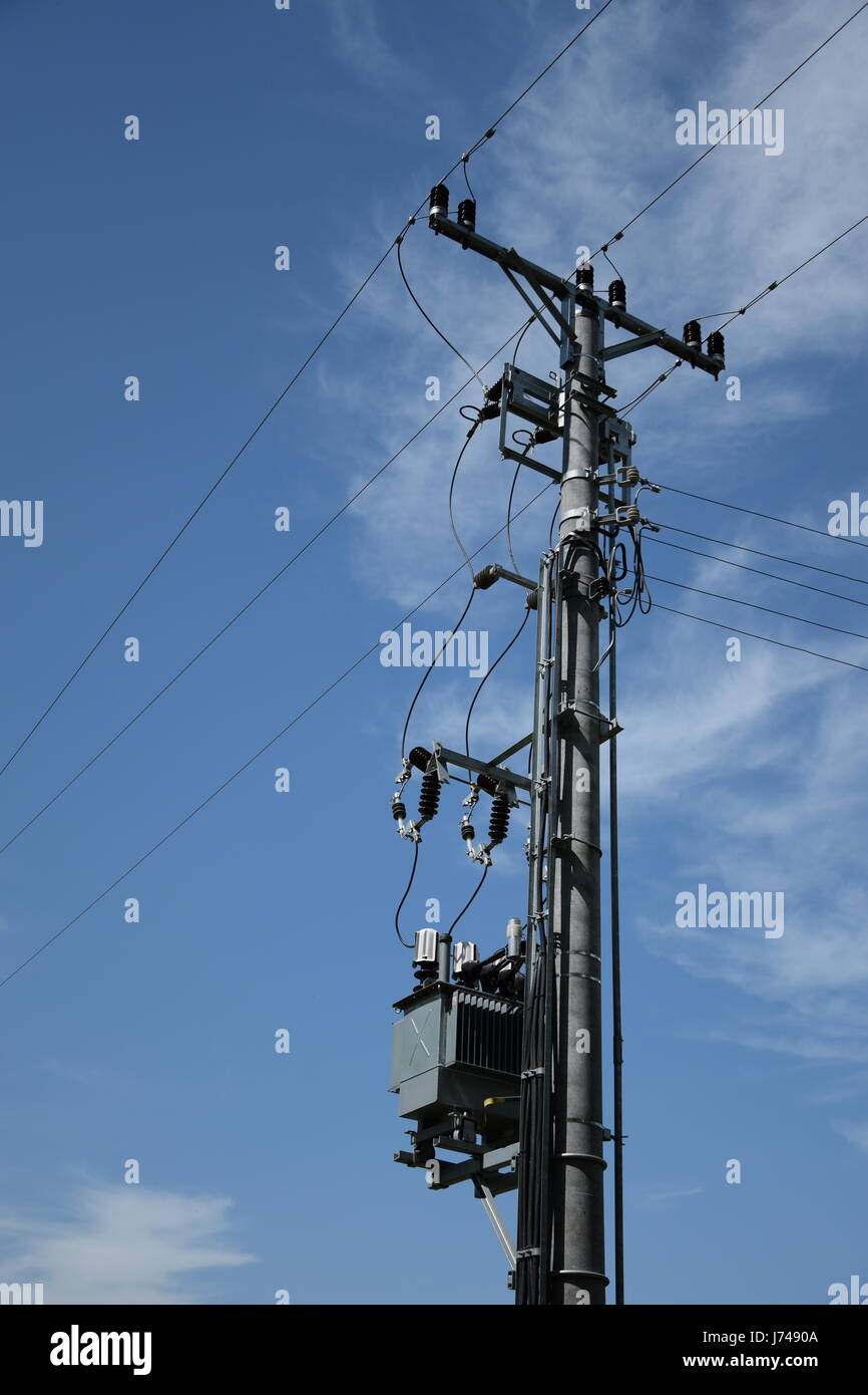 low-voltage-power-transmission-line-against-blue-sky-and-clouds-J7490A.jpg