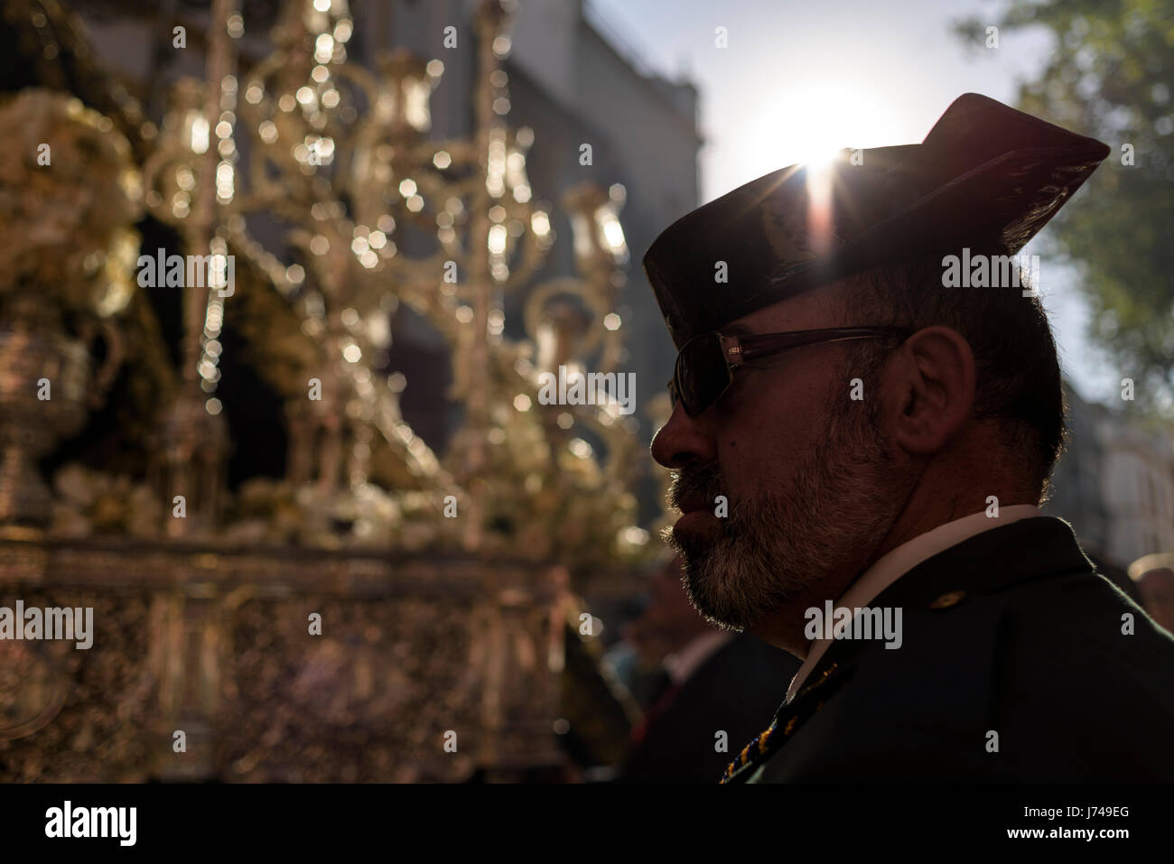 Member of the Guardia Civil police corps in front of the image of Jesus Christ. During the Easter week, processions with the image of Christ and the v Stock Photo