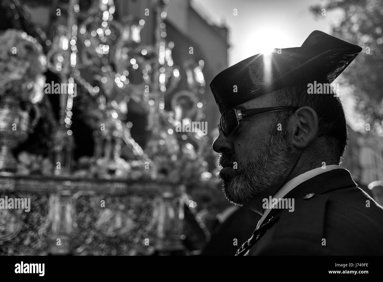Member of the Guardia Civil police corps in front of the image of Jesus Christ. During the Easter week, processions with the image of Christ and the v Stock Photo