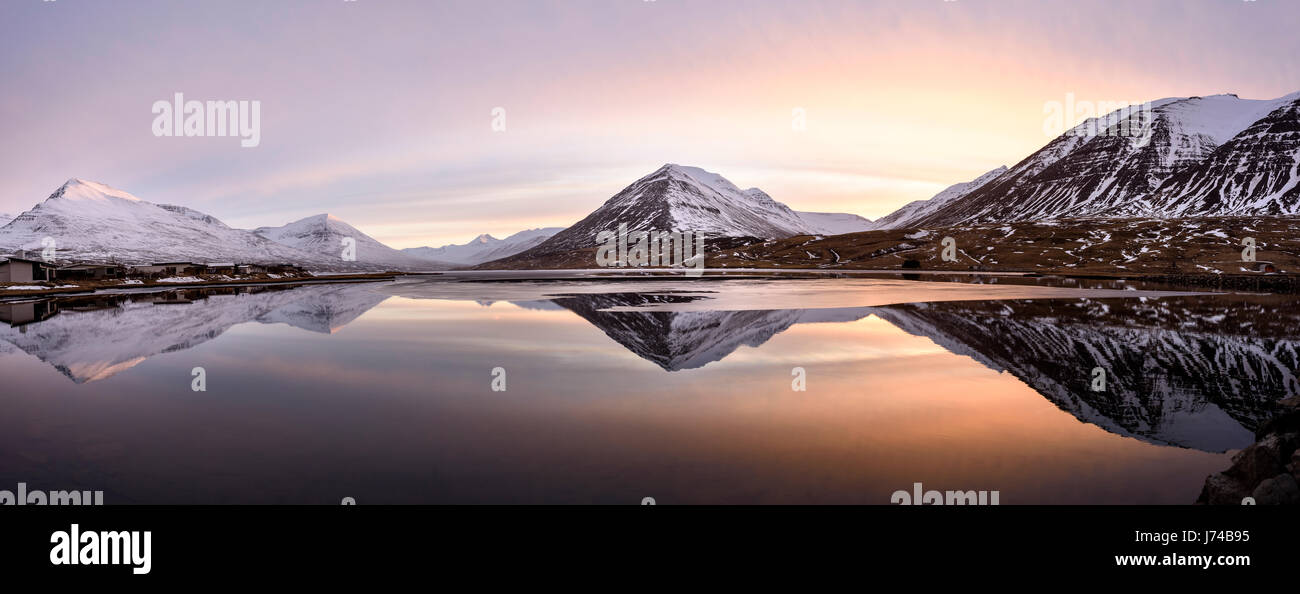 Red sun setting over the mountains of North Iceland on a winter clear day. Stock Photo