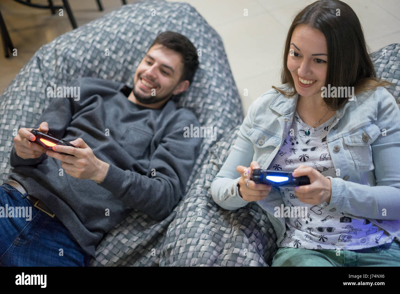 Young Cute Competitive Boyfriend Girlfriend Playing Video Games In Couch  Stock Photo, Picture and Royalty Free Image. Image 34313215.