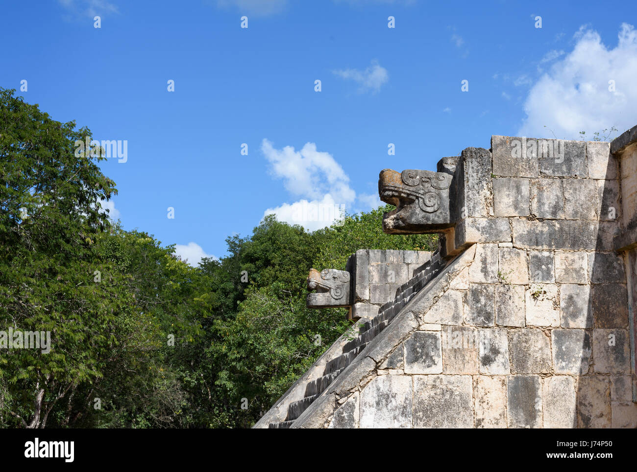 stone jaguar head statue at the Platform of the Eagles and Jaguars in Mayan Ruins of Chichen Itza, Mexico Stock Photo