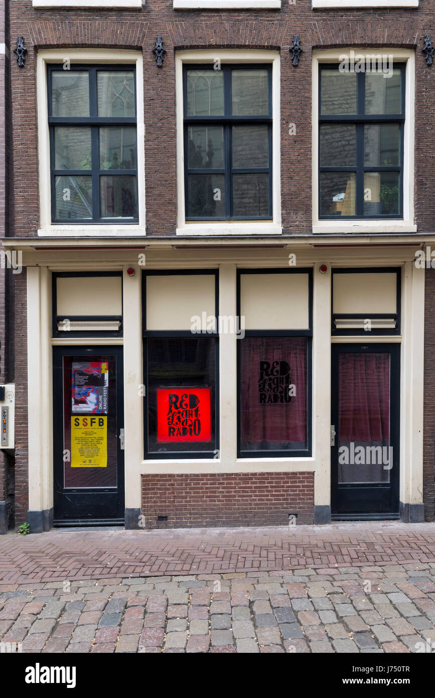 AMSTERDAM, NETHERLANDS - MAY, 16, 2017: Red Light Radio is an online radio station broadcasting from a former prostitution window in the red light dis Stock Photo