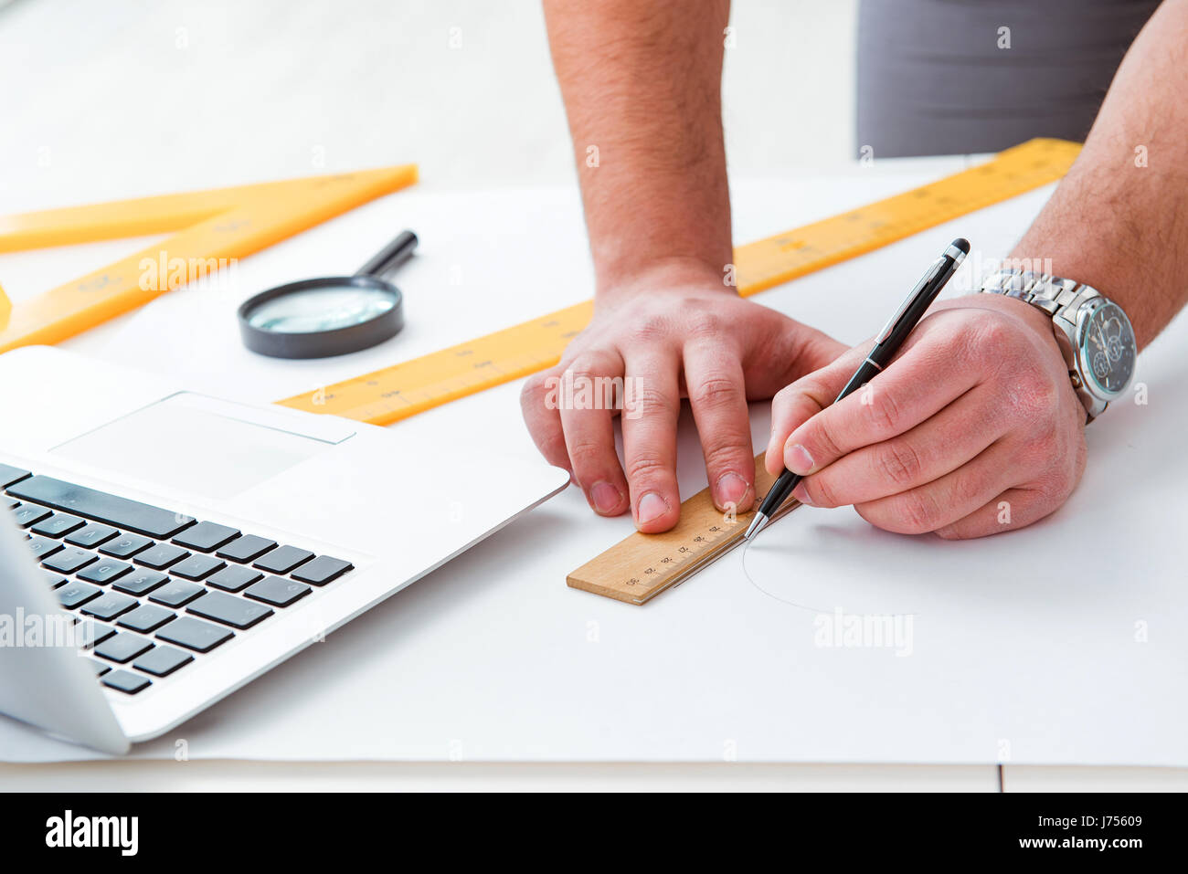 Workign Drawing Engineering Male engineer working on drawings and blueprints Stock Photo - Alamy