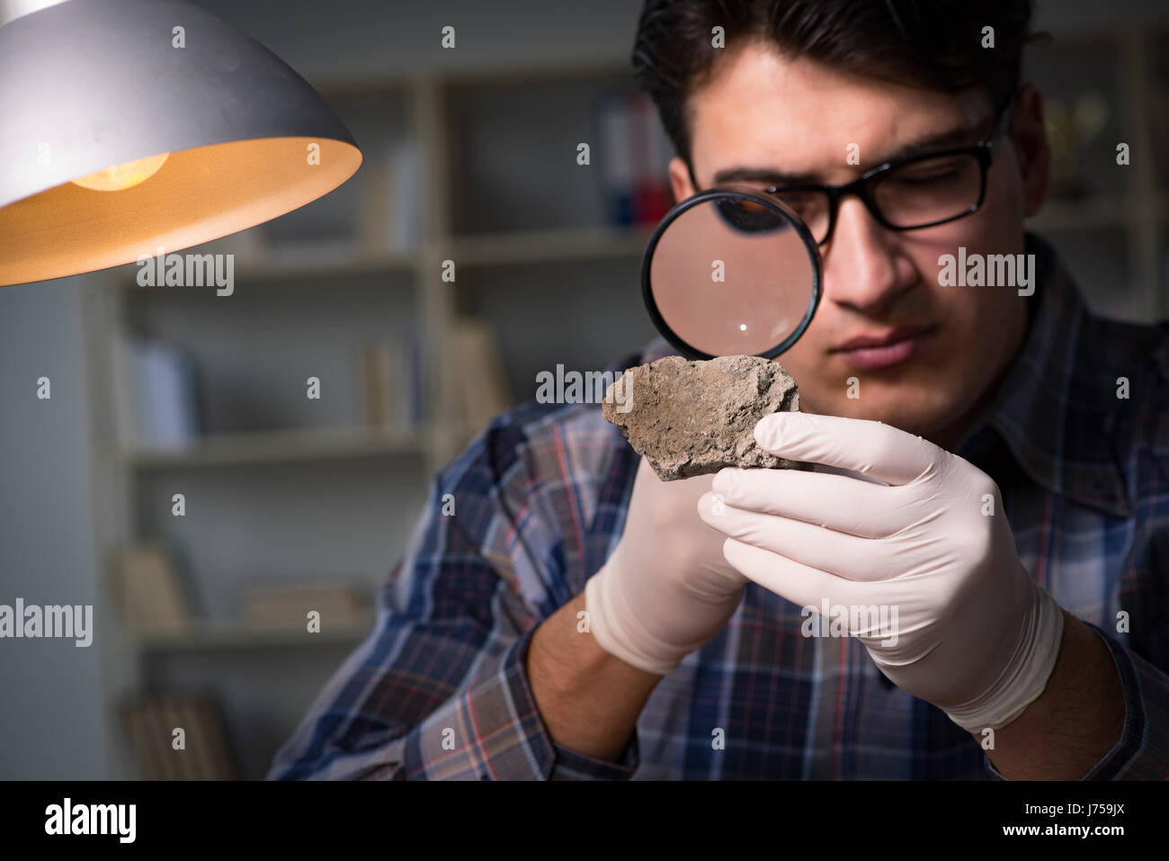 Archeologist working late night in office Stock Photo Alamy