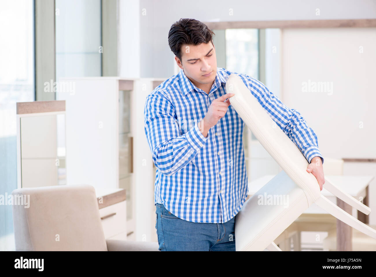Young man shopping in furniture store Stock Photo - Alamy
