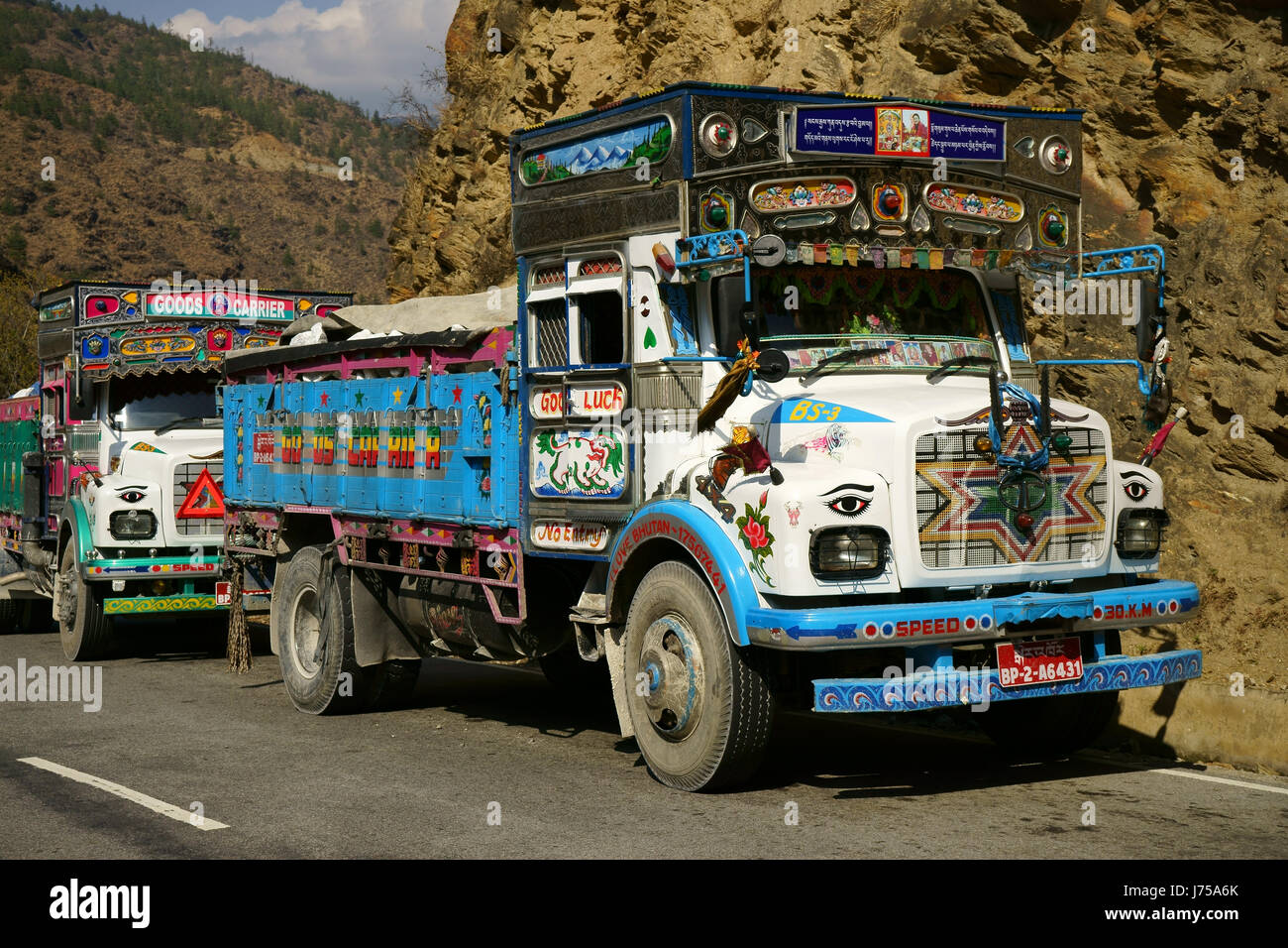 Decorated and painted trucks at intersection of highway Paro to Thimphu, Bhutan Stock Photo